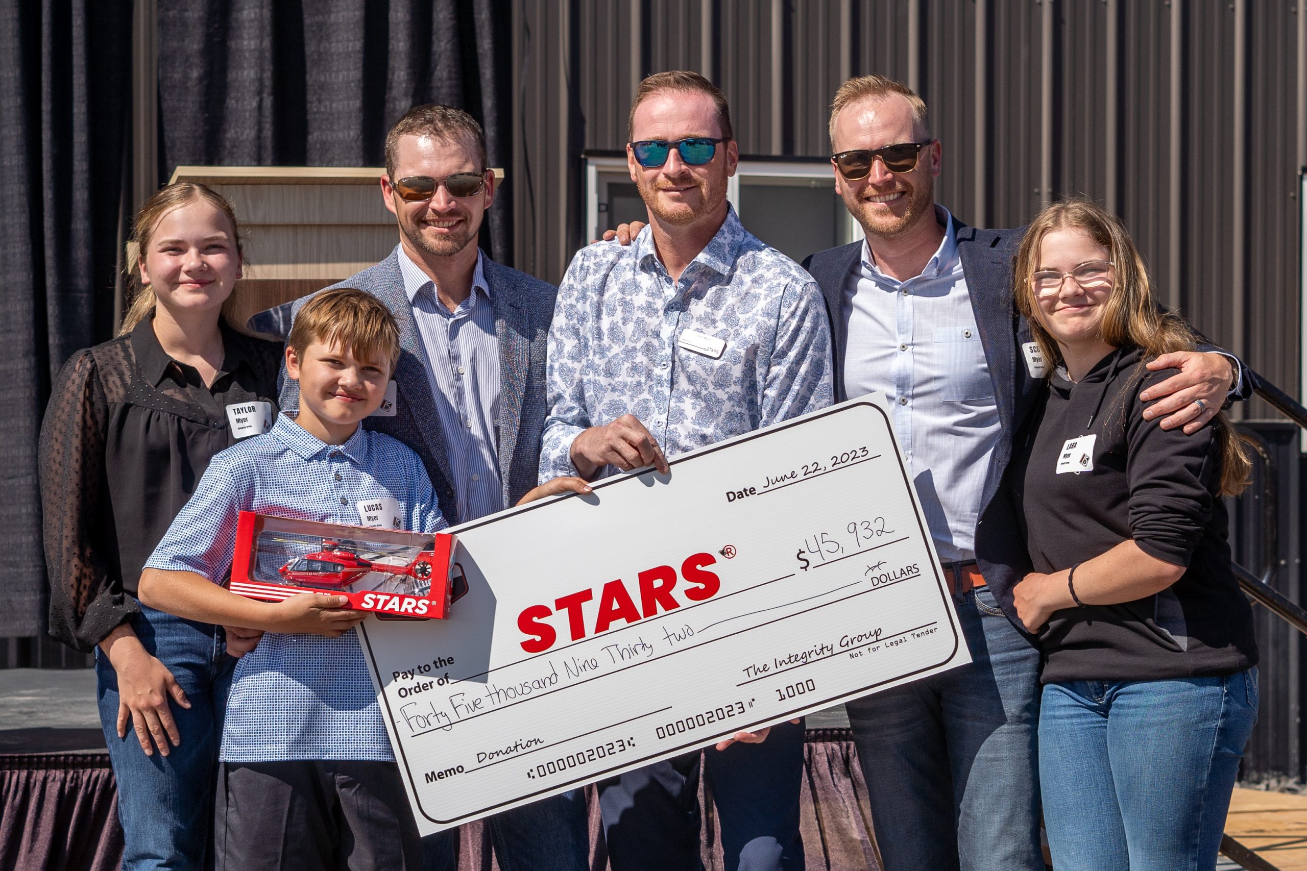Integrity donating a large cheque to STARS Air Ambulance