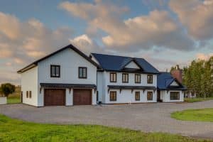 Front view of the award-winning Modern Farmhouse built by Integrity Post Structures, showcasing its sleek design and high-end finishes.