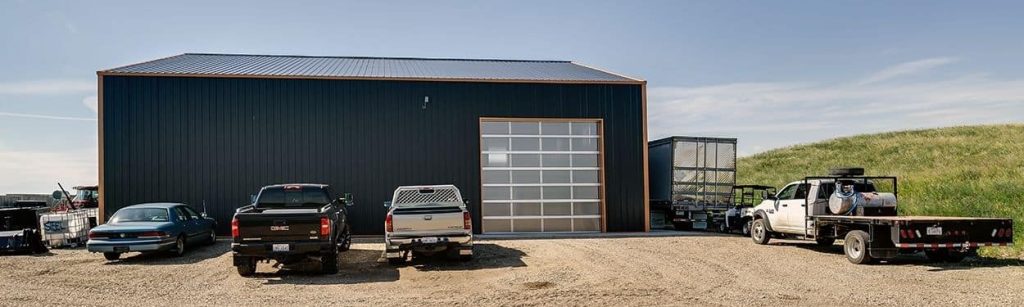 A copper penny agricultural post-frame shop with a bi-fold door