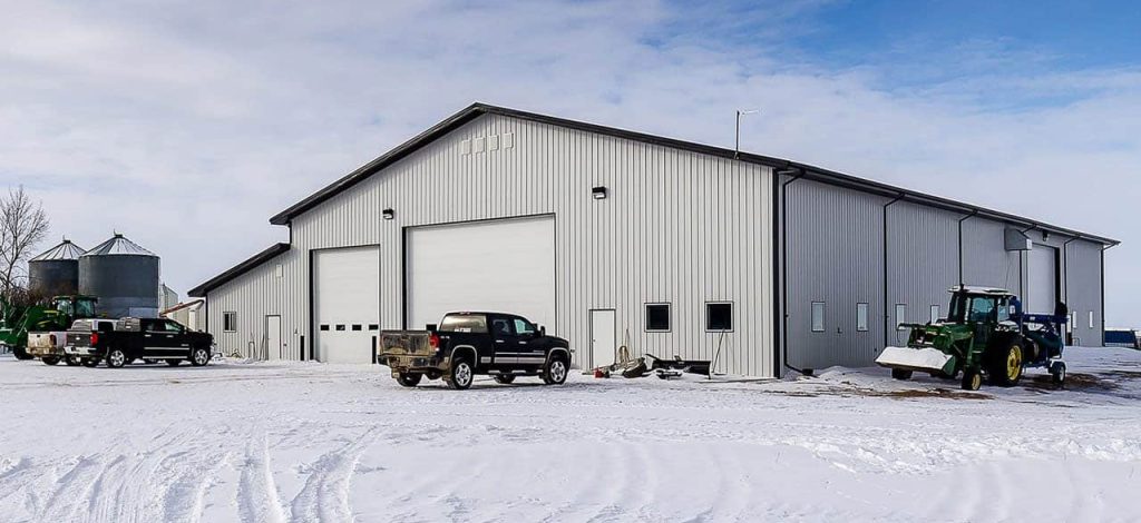 an Iron ore agricultural post-frame shop with three overhead doors and bi-fold door