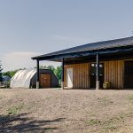 A Charcoal Steel post-frame horse Barn