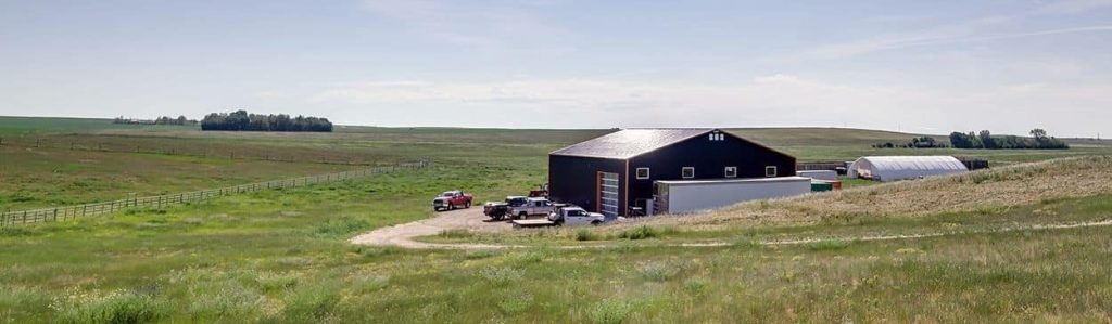 A copper penny agricultural post-frame shop with a bi-fold door