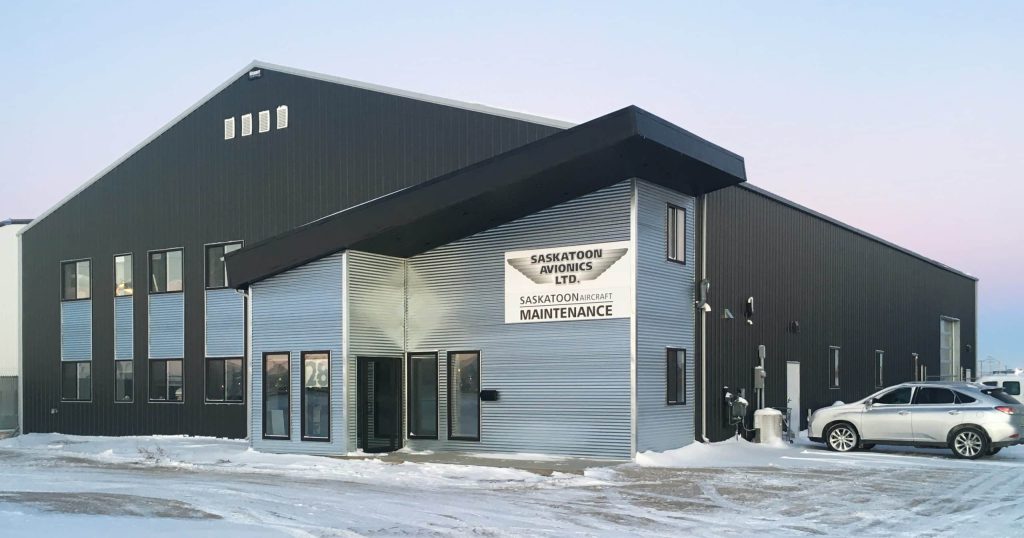 An iron ore post-frame commercial build with a bi-fold door