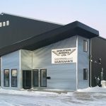 An iron ore post-frame commercial build with a bi-fold door
