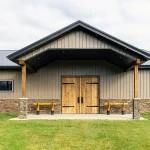 A buckskin post-frame equestrian barn