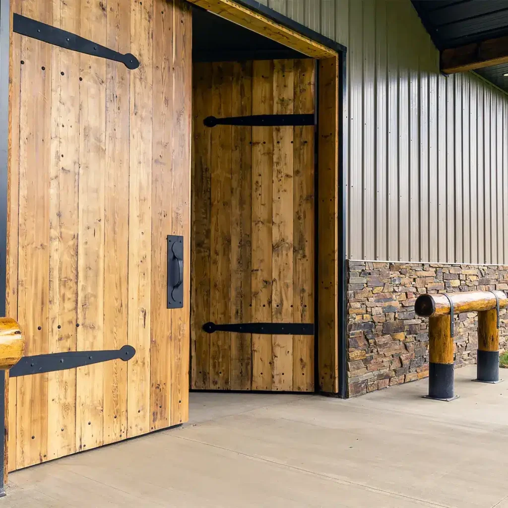 A buckskin post-frame equestrian barn