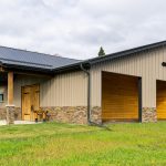 A buckskin post-frame equestrian barn