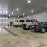 A dark red post-frame agricultural shop