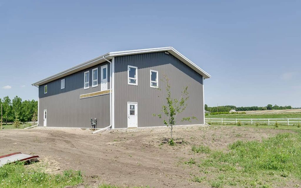 A charcoal lifestyle & Hobby post-frame shop with one chain overhead door