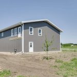 A charcoal lifestyle & Hobby post-frame shop with one chain overhead door