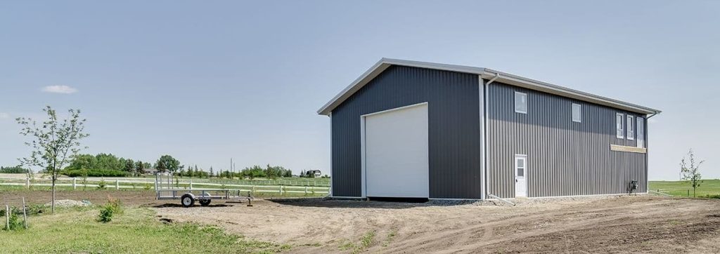 A charcoal lifestyle & Hobby post-frame shop with one chain overhead door