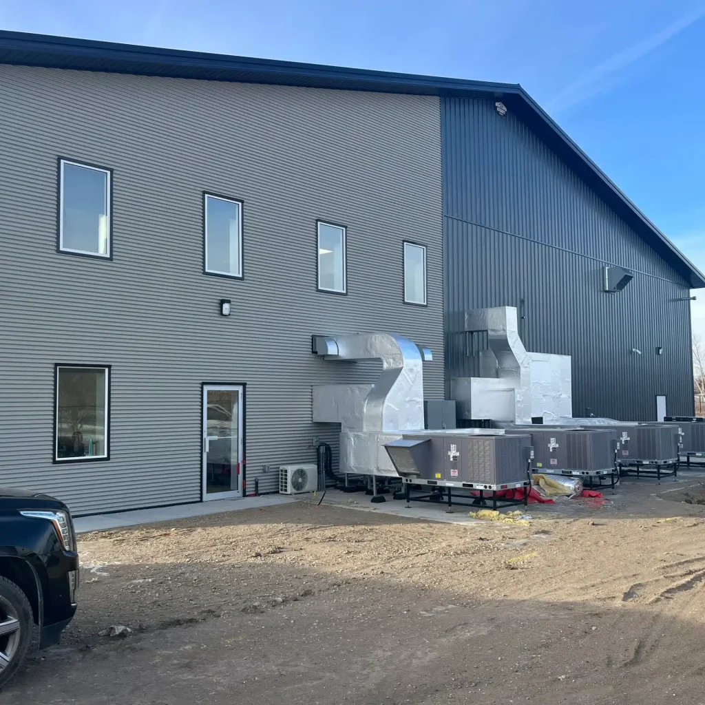 A gunmetal post-frame commercial building