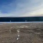 A gunmetal post-frame commercial building