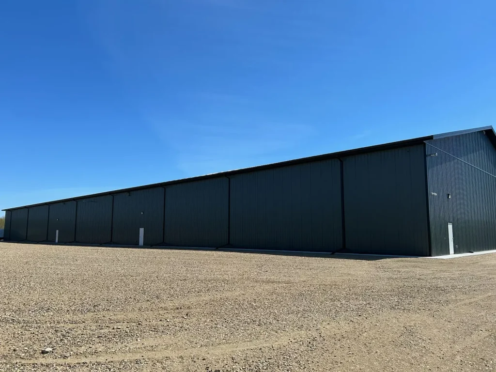 A gunmetal post-frame commercial building