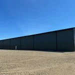 A gunmetal post-frame commercial building