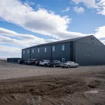 A gunmetal post-frame pickleball hobby shop