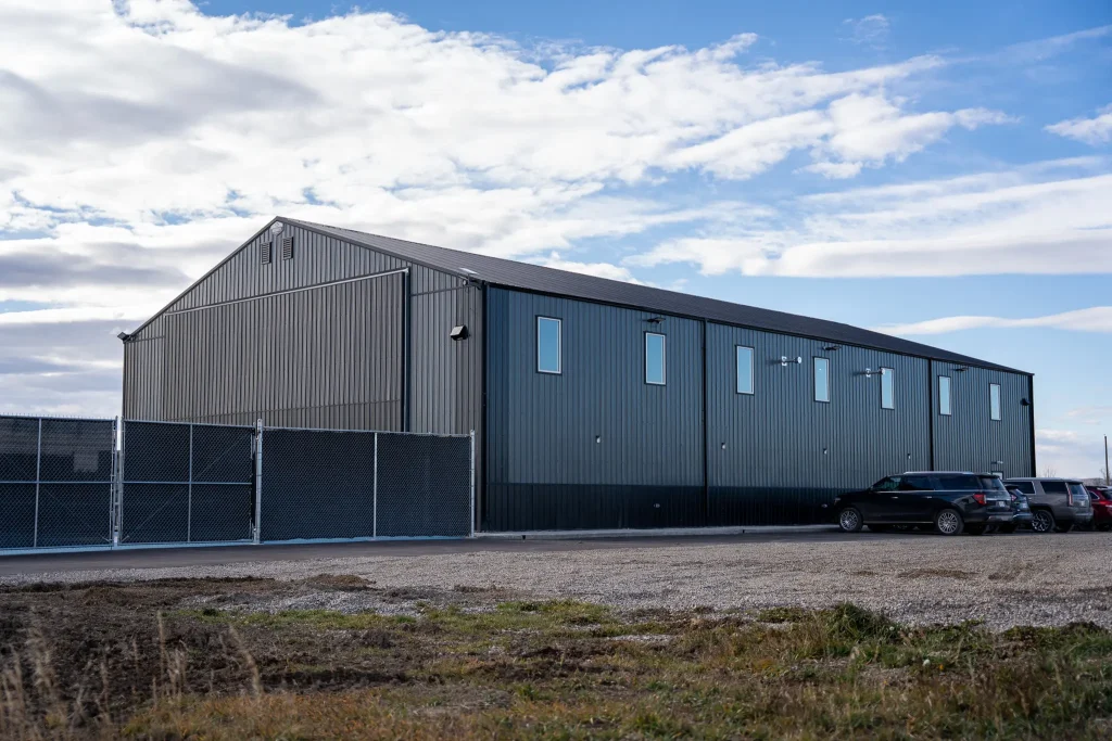 A gunmetal post-frame pickleball hobby shop