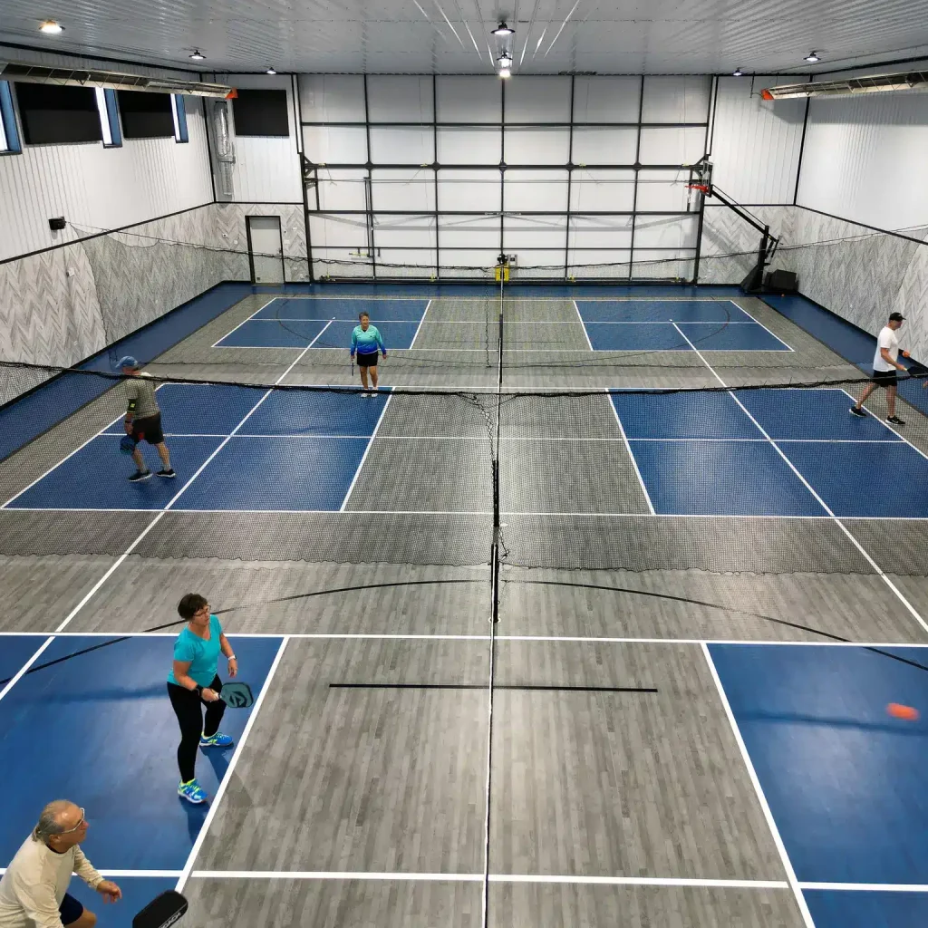 A gunmetal post-frame pickleball hobby shop