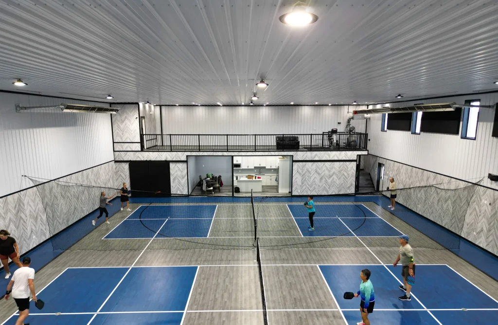 A gunmetal post-frame pickleball hobby shop