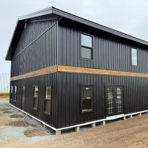 A black post-frame hangar