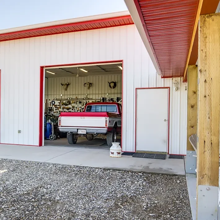 A white post-frame lifestyle & hobby shop