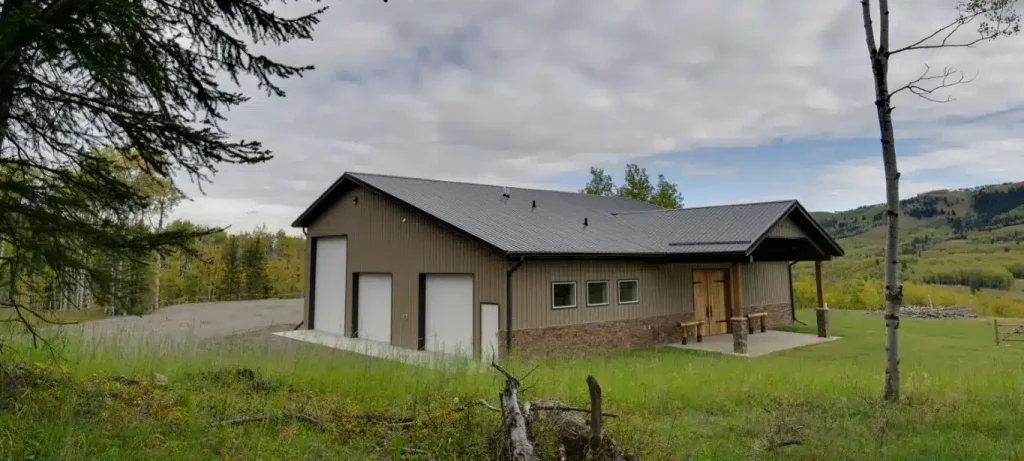 A buckskin post-frame equestrian barn