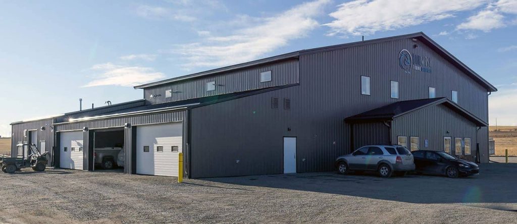 A charcoal post-frame commercial building