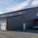 A charcoal post-frame commercial building