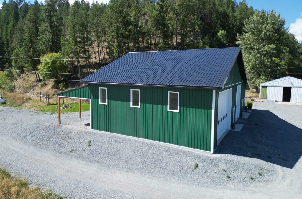 A melchers green lifestyle & Hobby post-frame shop with two overhead doors and soffits