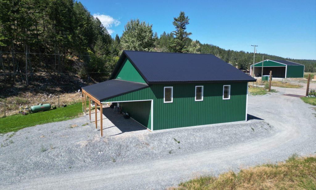 A melchers green lifestyle & Hobby post-frame shop with two overhead doors and soffits