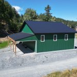 A melchers green lifestyle & Hobby post-frame shop with two overhead doors and soffits