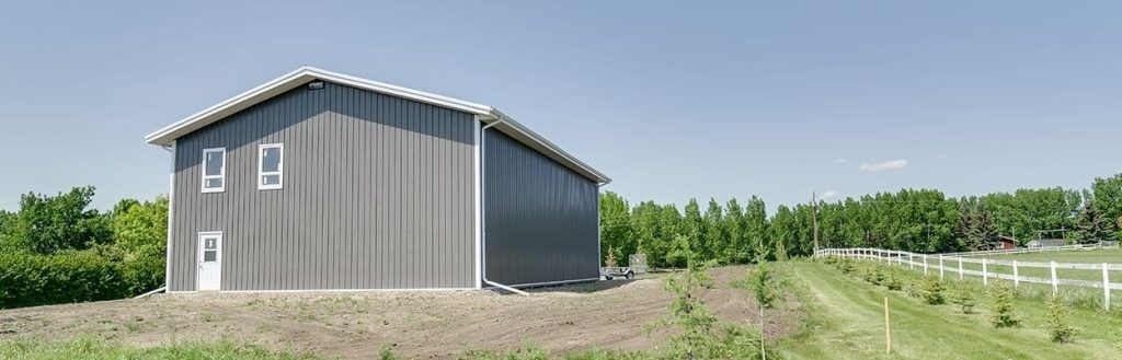 A charcoal lifestyle & Hobby post-frame shop with one chain overhead door