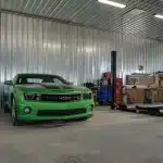 A buckskin lifestyle & Hobby post-frame shop with wainscotting, soffits, and one overhead door