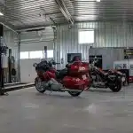 A buckskin lifestyle & Hobby post-frame shop with wainscotting, soffits, and one overhead door