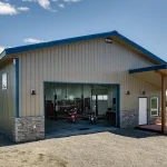 A buckskin lifestyle & Hobby post-frame shop with wainscotting, soffits, and one overhead door