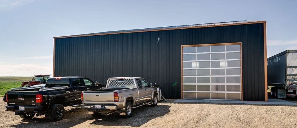 A copper penny agricultural post-frame shop with a bi-fold door