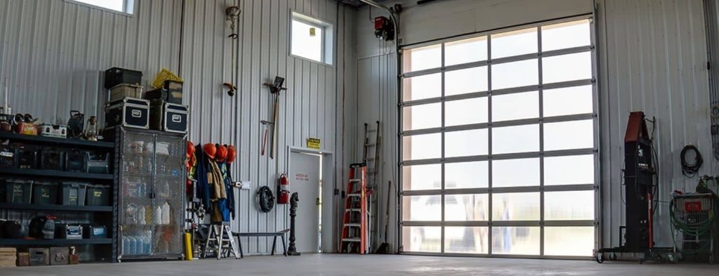 A copper penny agricultural post-frame shop with a bi-fold door
