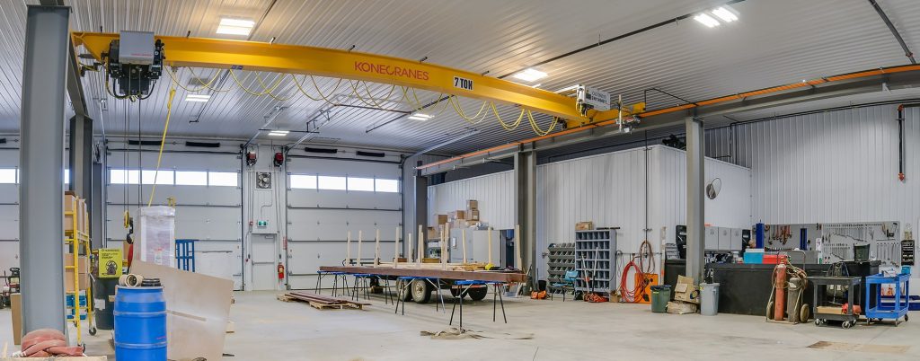 An iron ore post-frame commercial build with ten overhead doors