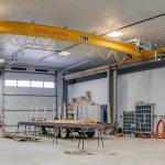 An iron ore post-frame commercial build with ten overhead doors