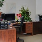 An iron ore post-frame commercial build with ten overhead doors