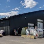 An iron ore post-frame commercial build with ten overhead doors