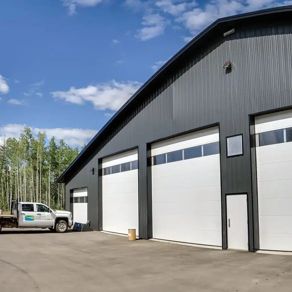 An iron ore post-frame commercial build with ten overhead doors