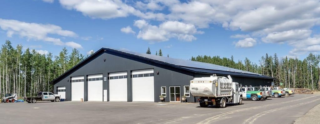 An iron ore post-frame commercial build with ten overhead doors