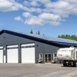 An iron ore post-frame commercial build with ten overhead doors