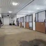 A charcoal post-frame commercial building