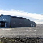 A charcoal post-frame commercial building