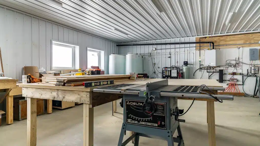 A dark red post-frame agricultural shop