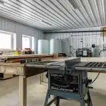A dark red post-frame agricultural shop