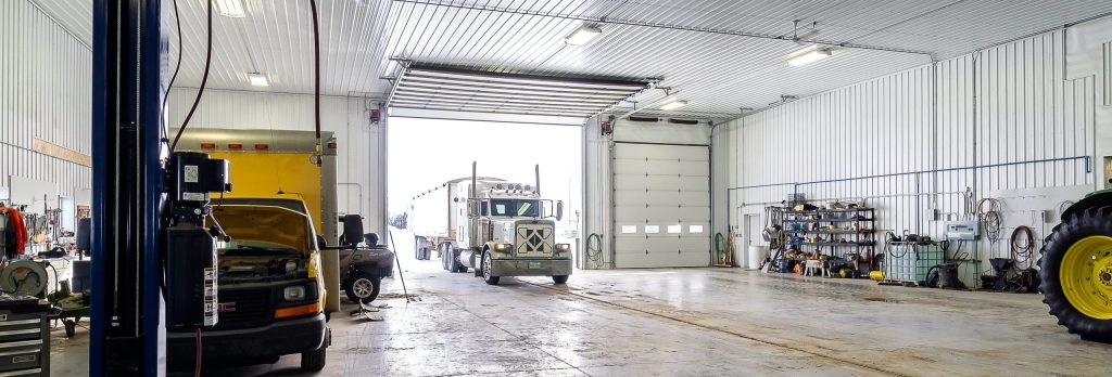 an Iron ore agricultural post-frame shop with three overhead doors and bi-fold door