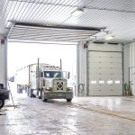 an Iron ore agricultural post-frame shop with three overhead doors and bi-fold door